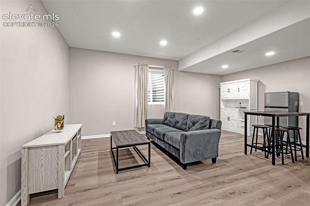 Image 28 of 49: Spacious second living/entertainment in the basement featuring recessed lig