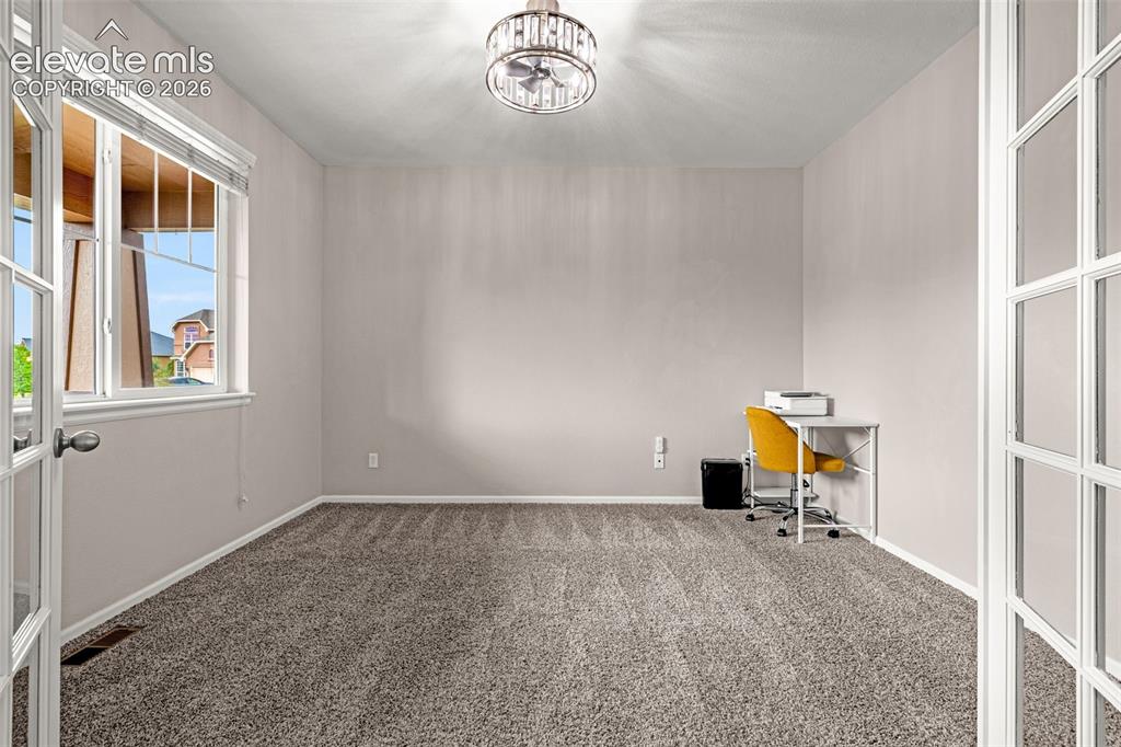 Image 4 of 49: Room featuring neutral wall paint, gray textured carpeting, and a ceiling-m