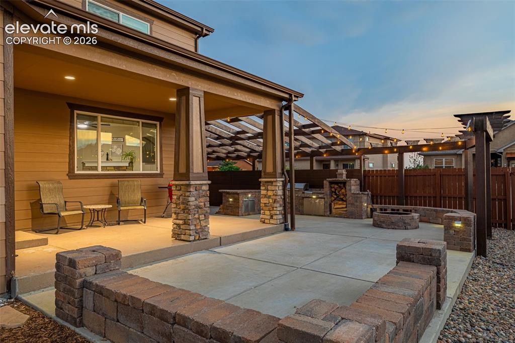 Image 40 of 49: Expansive outdoor living area featuring a covered patio with recessed light
