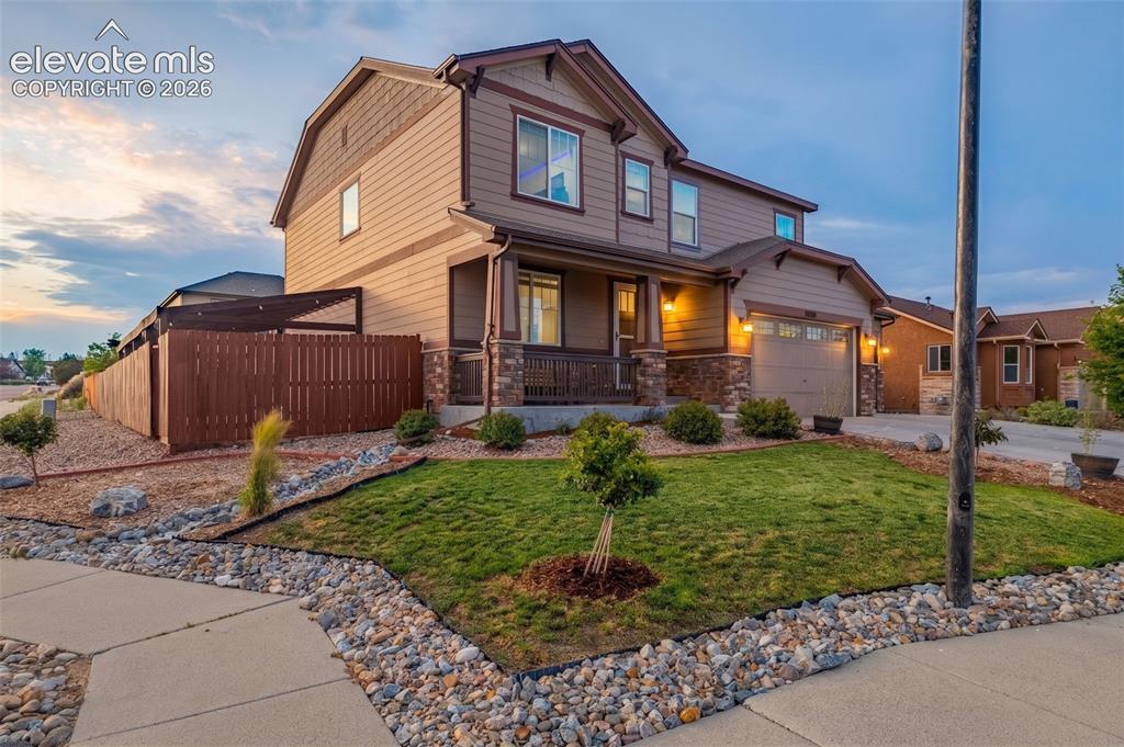 Image 41 of 49: Two-story residence featuring siding and stone exterior accents