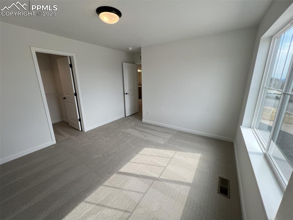 Image 12 of 17: Unfurnished bedroom with carpet floors and baseboards
