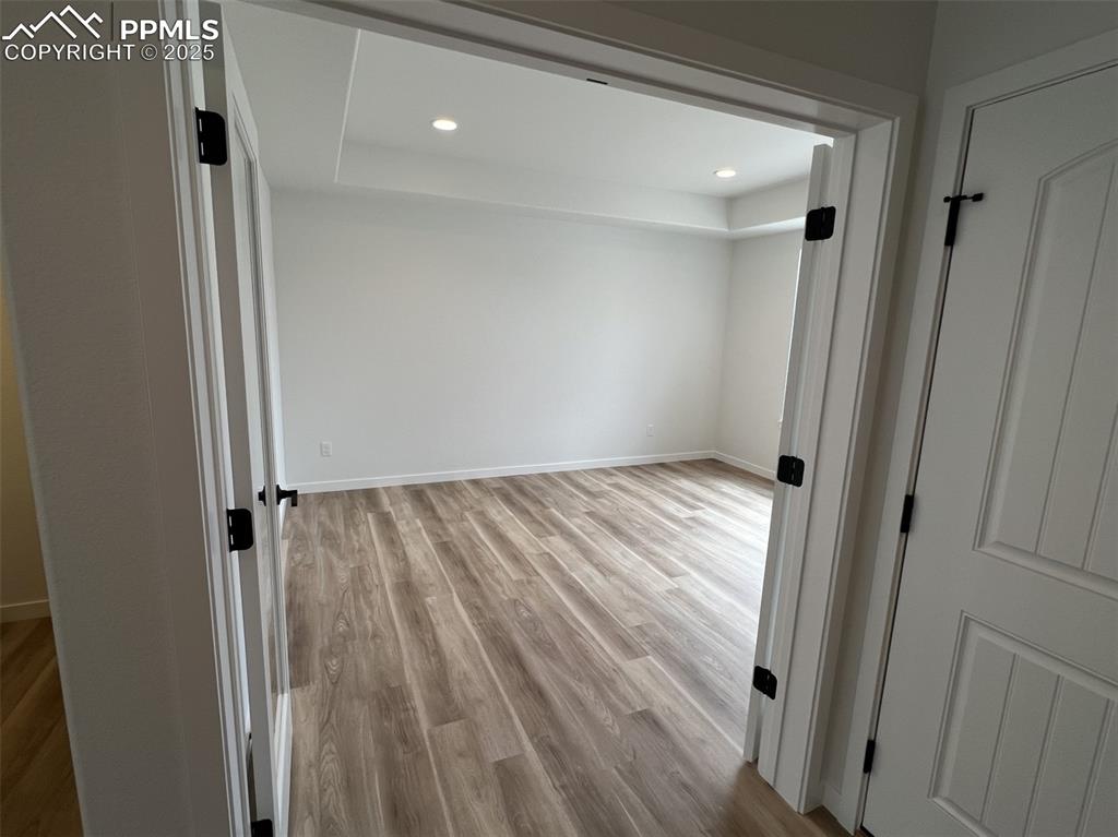Image 3 of 17: Study featuring light wood-type flooring and recessed lighting