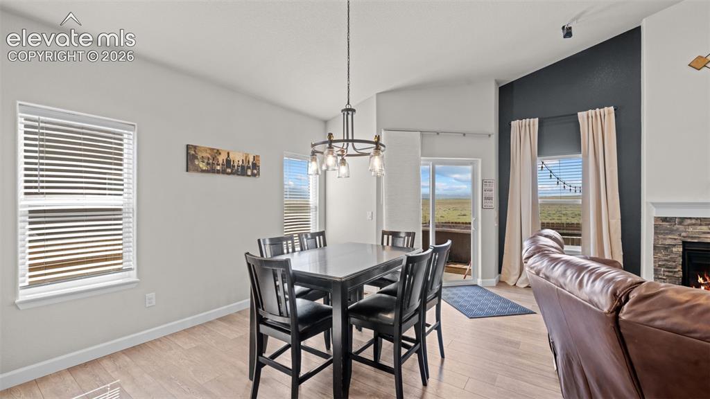Image 12 of 39: Open-concept living area featuring light wood-finish flooring, a contempora