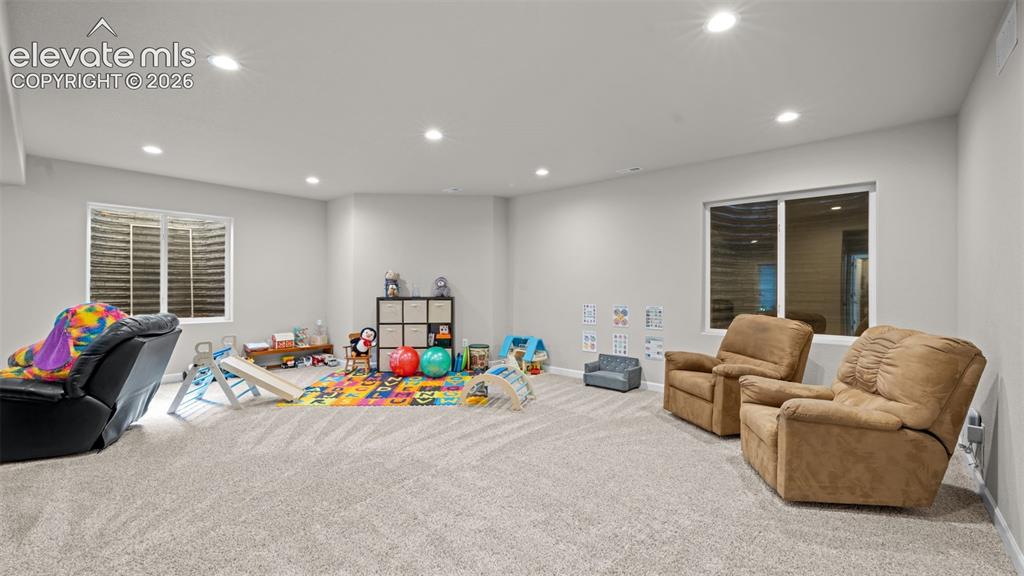 Image 24 of 39: Spacious room featuring light-toned carpeting and recessed lighting
