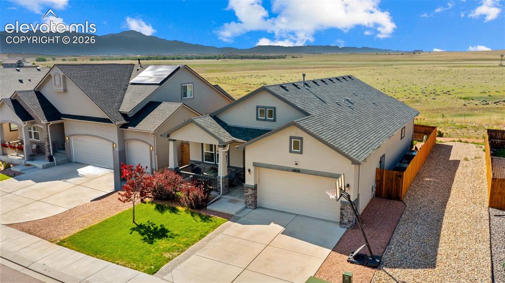 Image 32 of 39: Contemporary property with a light-toned exterior and dark shingle roofing