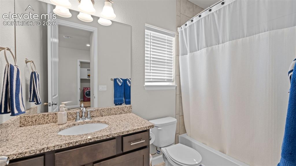 Image 6 of 39: Bathroom featuring a vanity with a light-colored granite-style countertop,