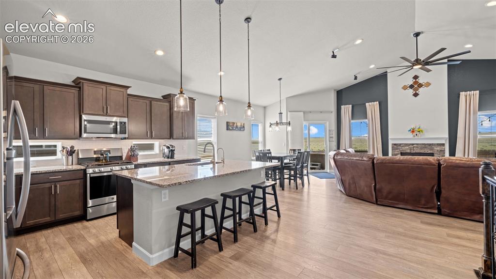 Image 8 of 39: Open-concept living space with wood-finish flooring throughout