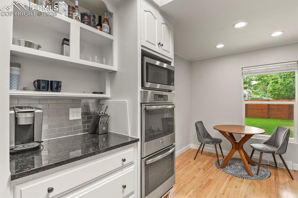 Image 10 of 48: Contemporary kitchen featuring stainless steel built-in double oven, white 