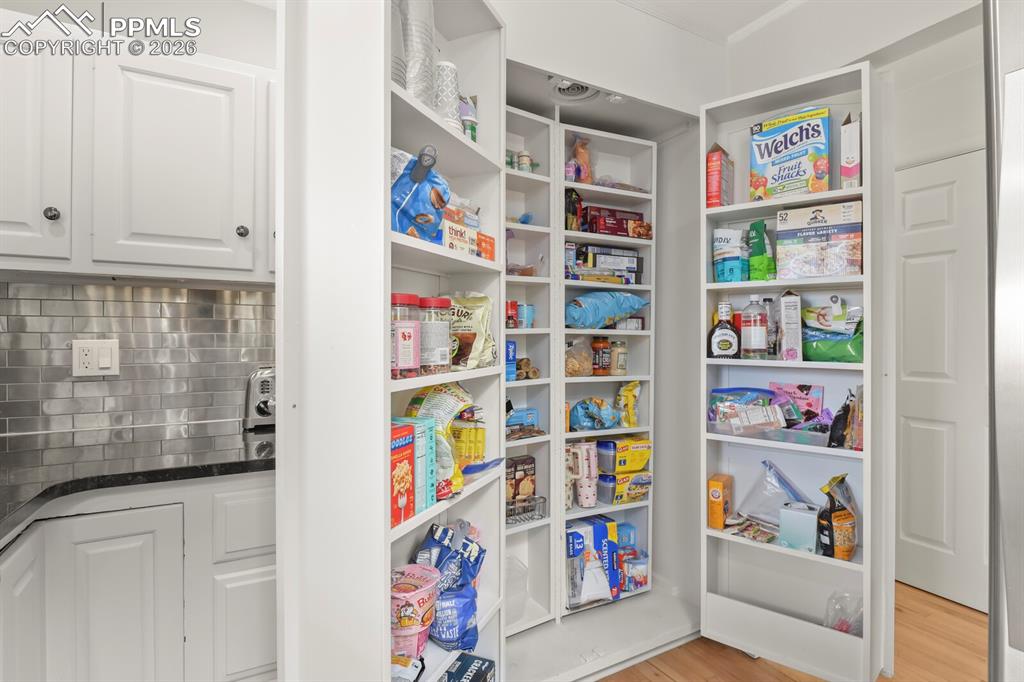 Image 12 of 48: Integrated pantry system featuring multiple tiered shelves