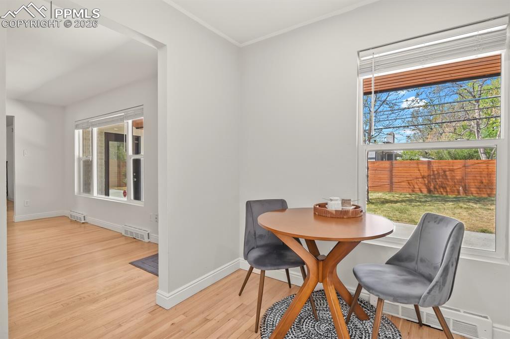 Image 13 of 48: Breakfast nook, hardwood flooring extends throughout the bright interior