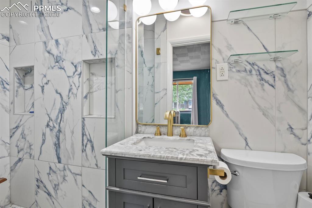 Image 19 of 48: Private primary 3/4 bathroom featuring large-format porcelain tile with blu