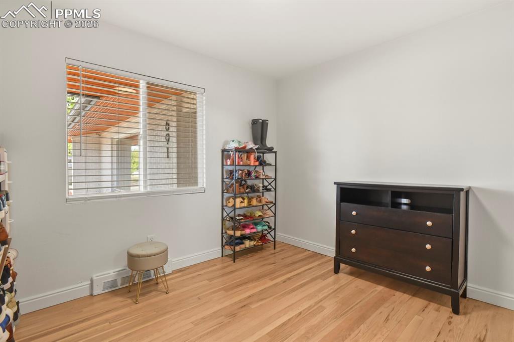 Image 20 of 48: 2nd bedroom on main level featuring hardwood flooring 