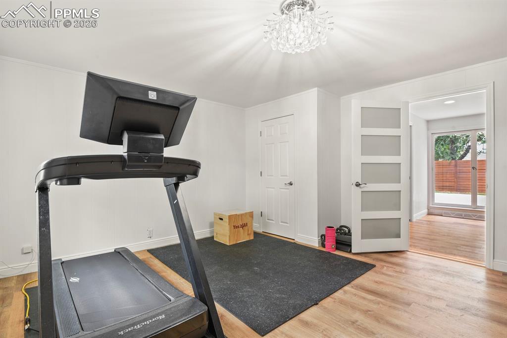 Image 25 of 48: 3rd bedroom on main level. Modern interior door with opaque glass panels, h
