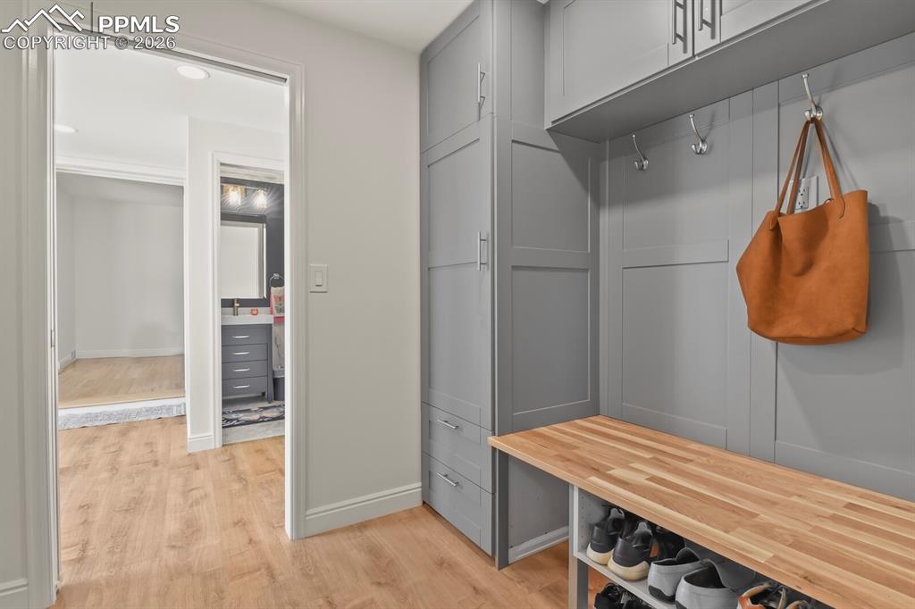 Image 28 of 48: Built-in gray cabinetry with a bench and shoe storage