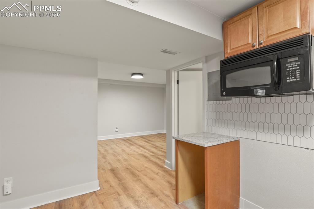 Image 35 of 48: Basement kitchenette semi open to the family room