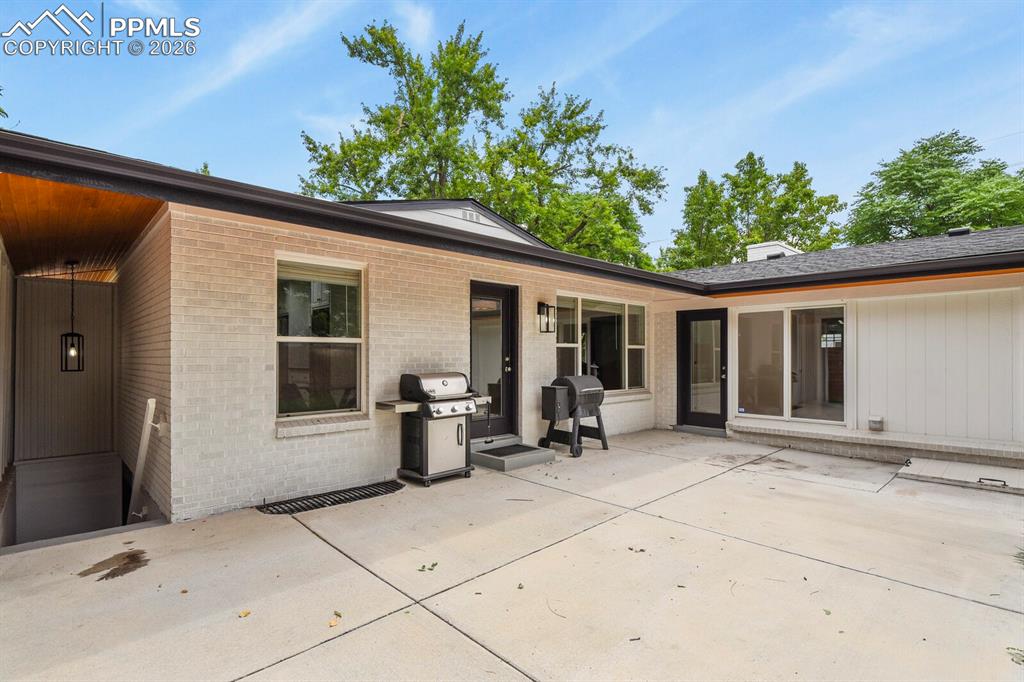 Image 41 of 48: Expansive concrete patio in backyard