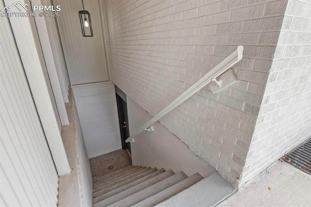 Image 42 of 48: Stairs in backyard leading to basement private entrance
