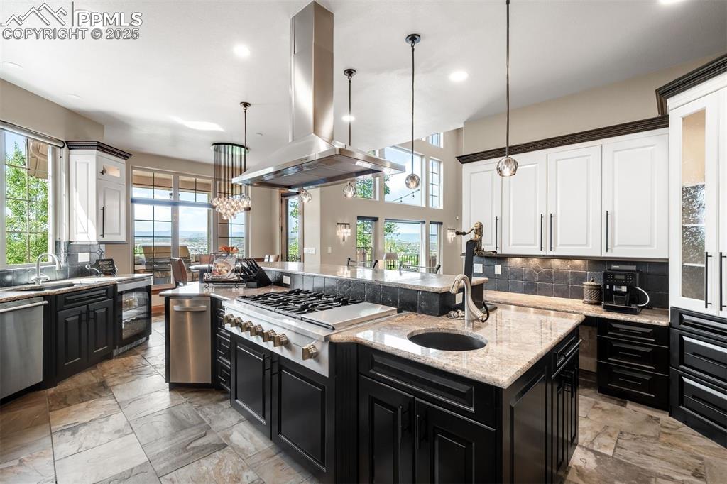 Image 13 of 47: Kitchen is gleaming with refreshed cabinetry, stainless GE Monogram applian