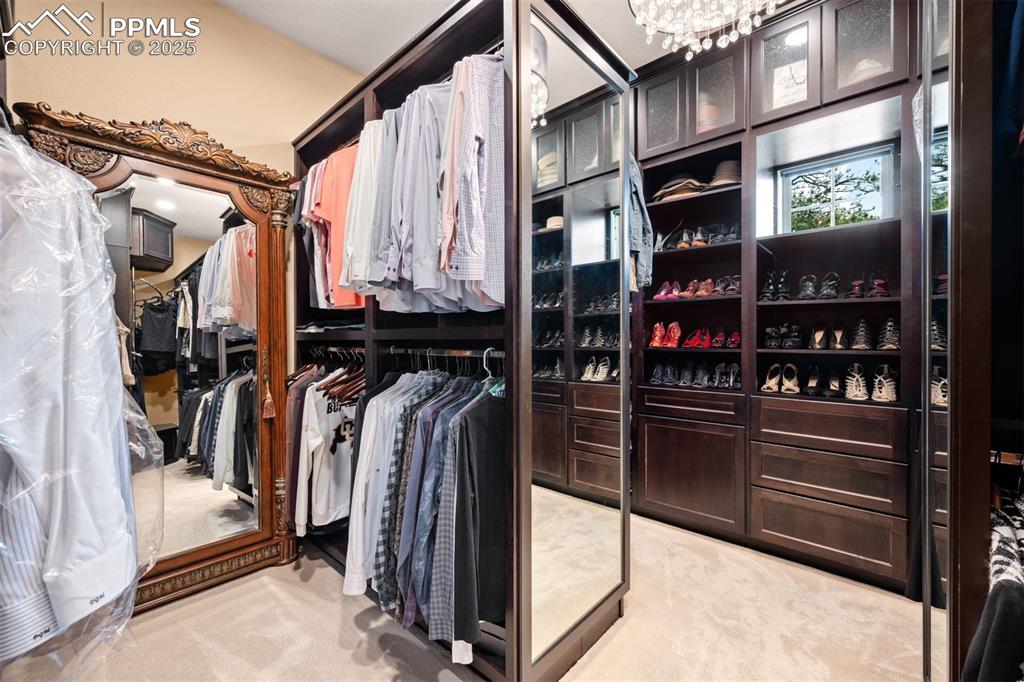 Image 23 of 47: The spacious walk-in closet features a custom built-in organization system,