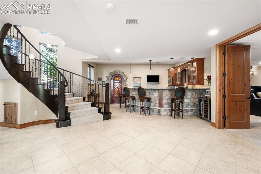 Image 27 of 47: The downstairs lounge is made for having fun with a well outfitted wet bar