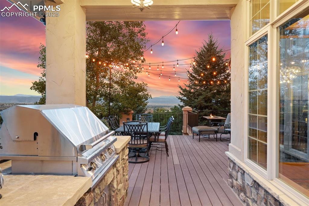 Image 38 of 47: Walk-out from the main level great room to the built in grill station & al