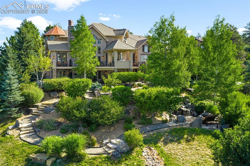 Image 42 of 47: Enjoy year round color with established evergreen & Aspen trees, flowering