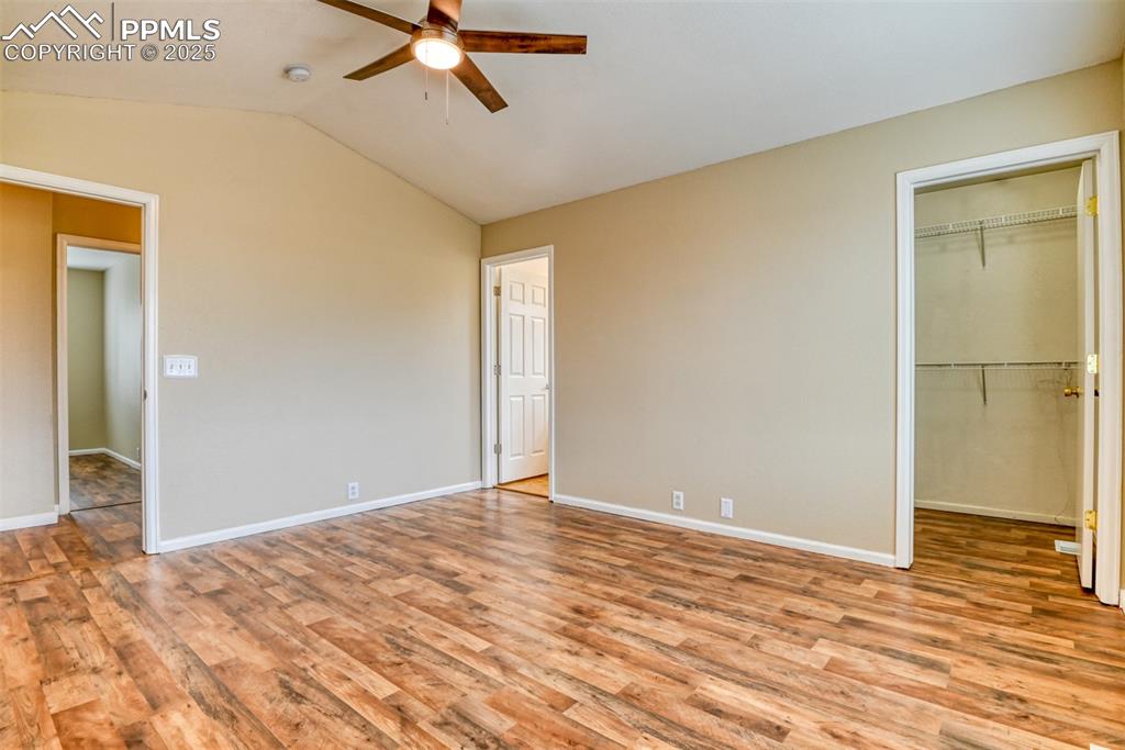 Image 10 of 21: Unfurnished bedroom featuring light wood-style flooring, a walk in closet, 