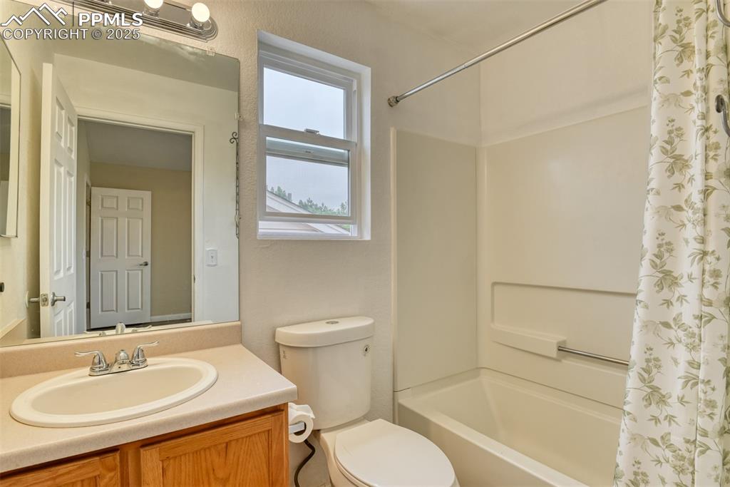 Image 12 of 21: Full bath with shower / bathtub combination with curtain and vanity