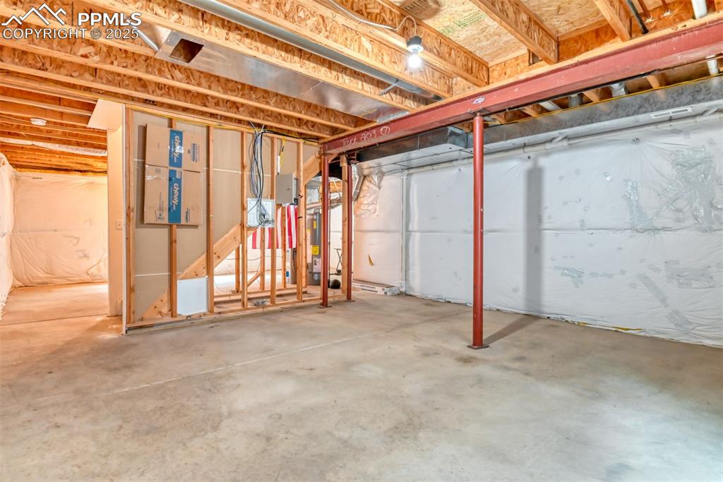 Image 18 of 21: Unfinished basement with gas water heater