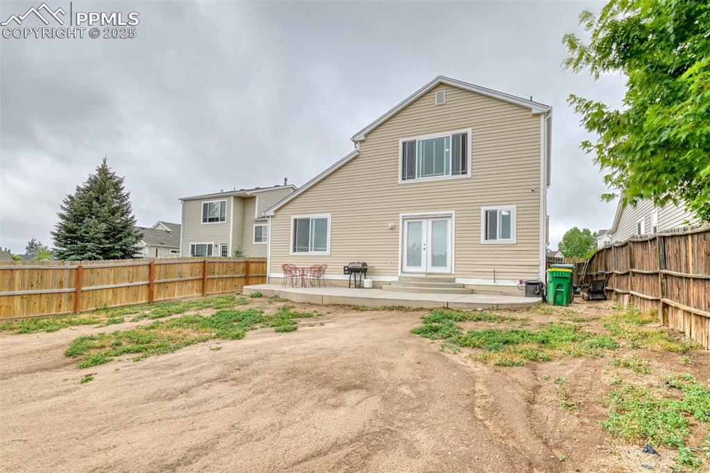 Image 21 of 21: Rear view of property featuring french doors, a patio area, a fenced backya