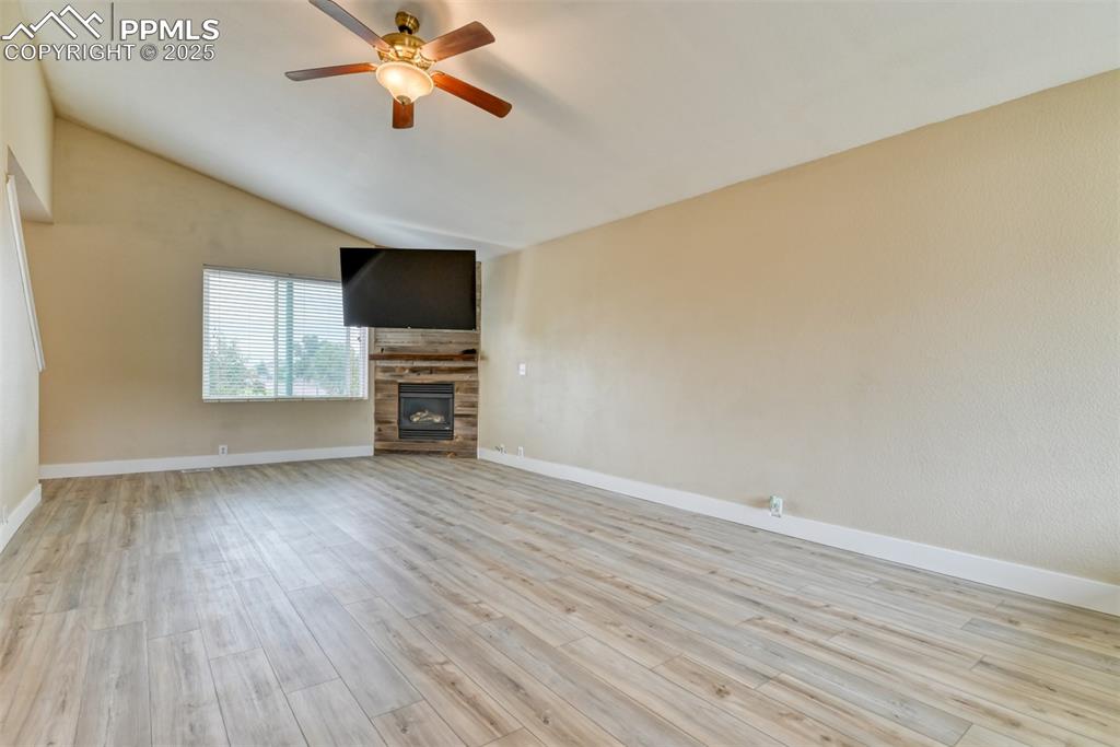 Image 3 of 21: Unfurnished living room featuring a ceiling fan, light wood finished floors