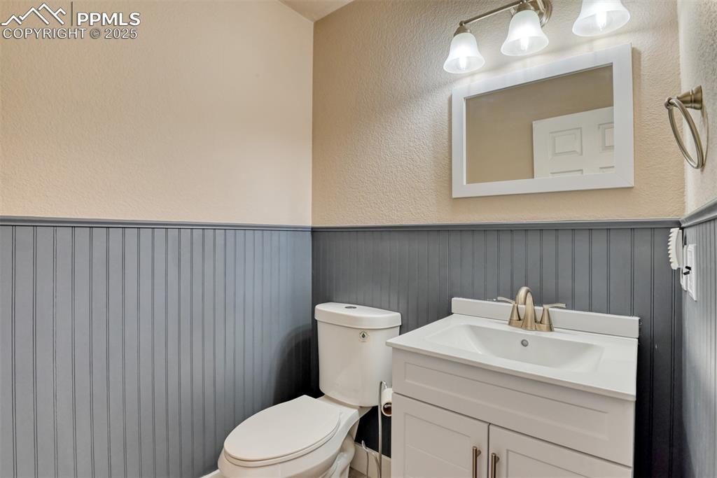 Image 8 of 21: Bathroom with wainscoting and vanity