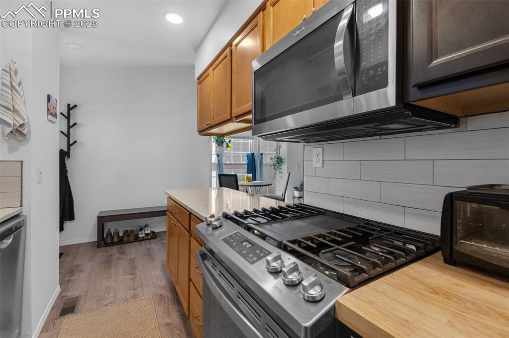 Image 13 of 26: Kitchen featuring appliances with stainless steel finishes, light luxury vi