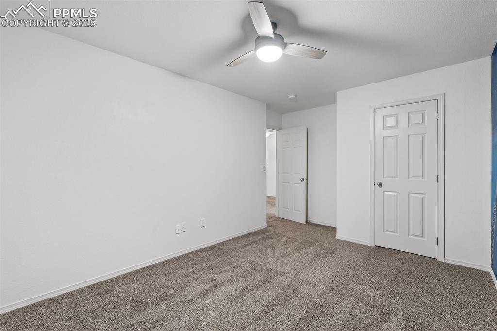 Image 11 of 20: Unfurnished bedroom featuring carpet floors and a ceiling fan