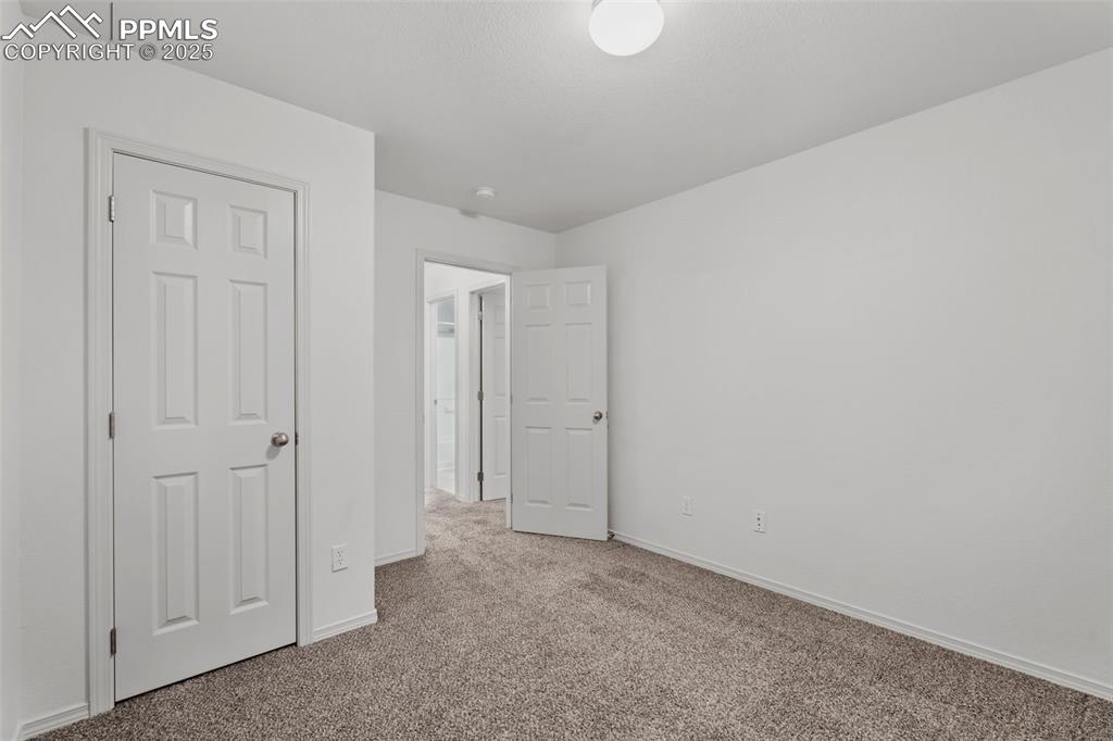 Image 14 of 20: Unfurnished bedroom featuring carpet and baseboards