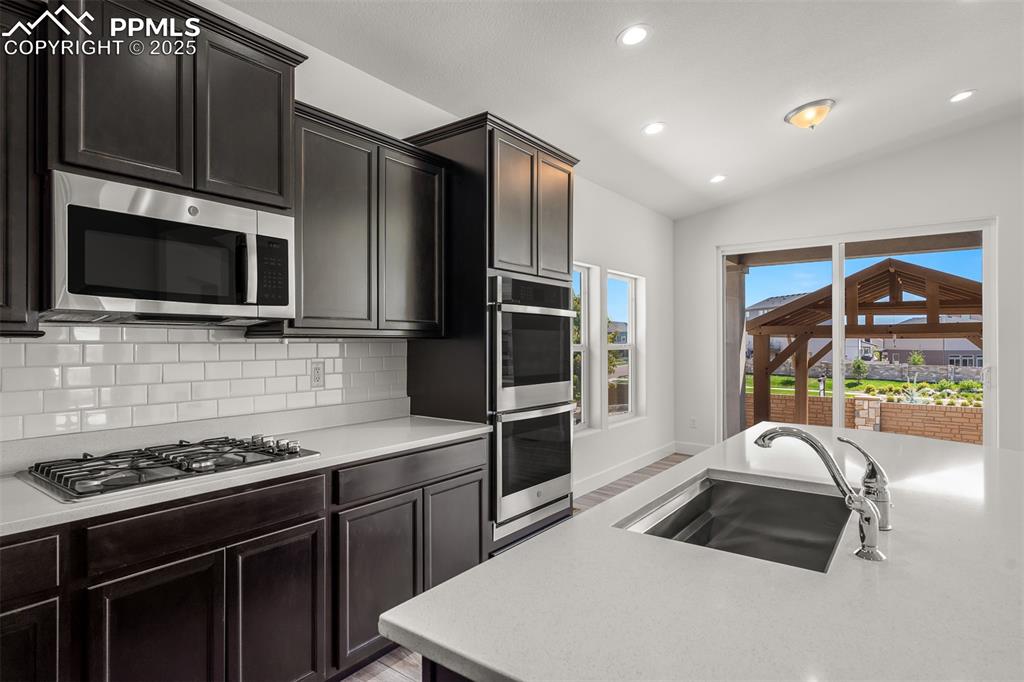 Image 16 of 46: Kitchen featuring appliances with stainless steel finishes, light counterto