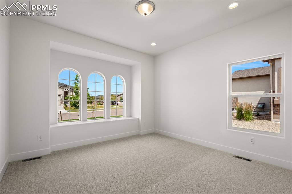 Image 34 of 46: Spare room featuring carpet and recessed lighting