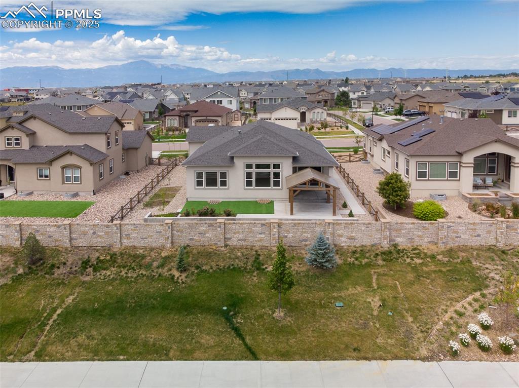 Image 4 of 46: Aerial view of residential area with mountains