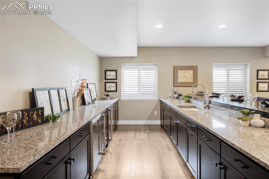 Image 32 of 48: Bar area includes sink and 2 under mount refrigerators.