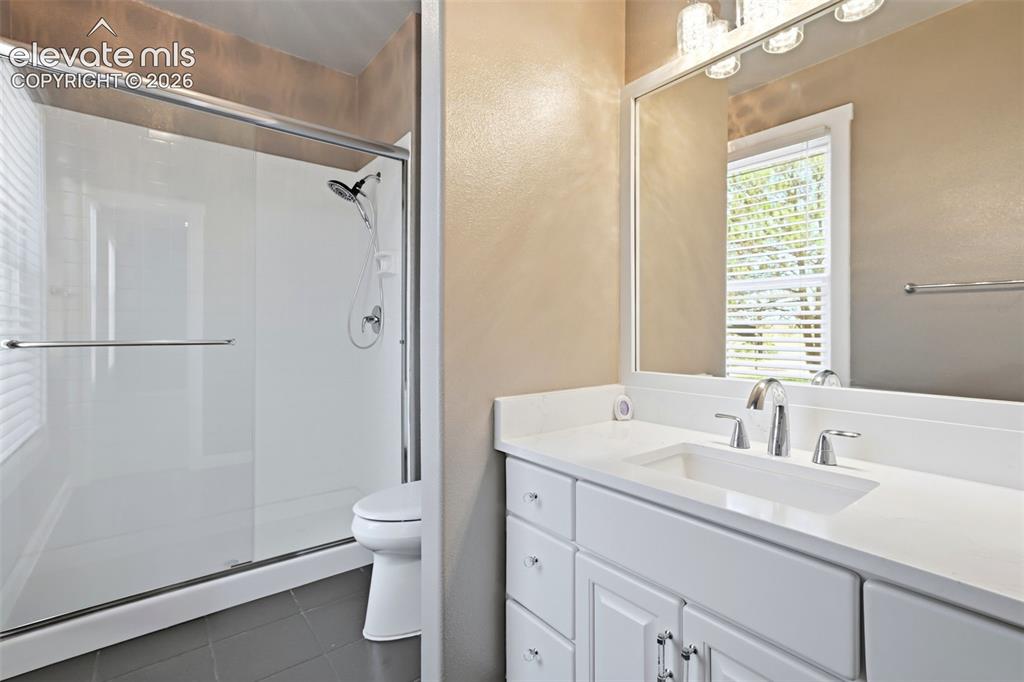 Image 34 of 40: Modern bathroom featuring a white vanity with integrated sink, chrome fixtu