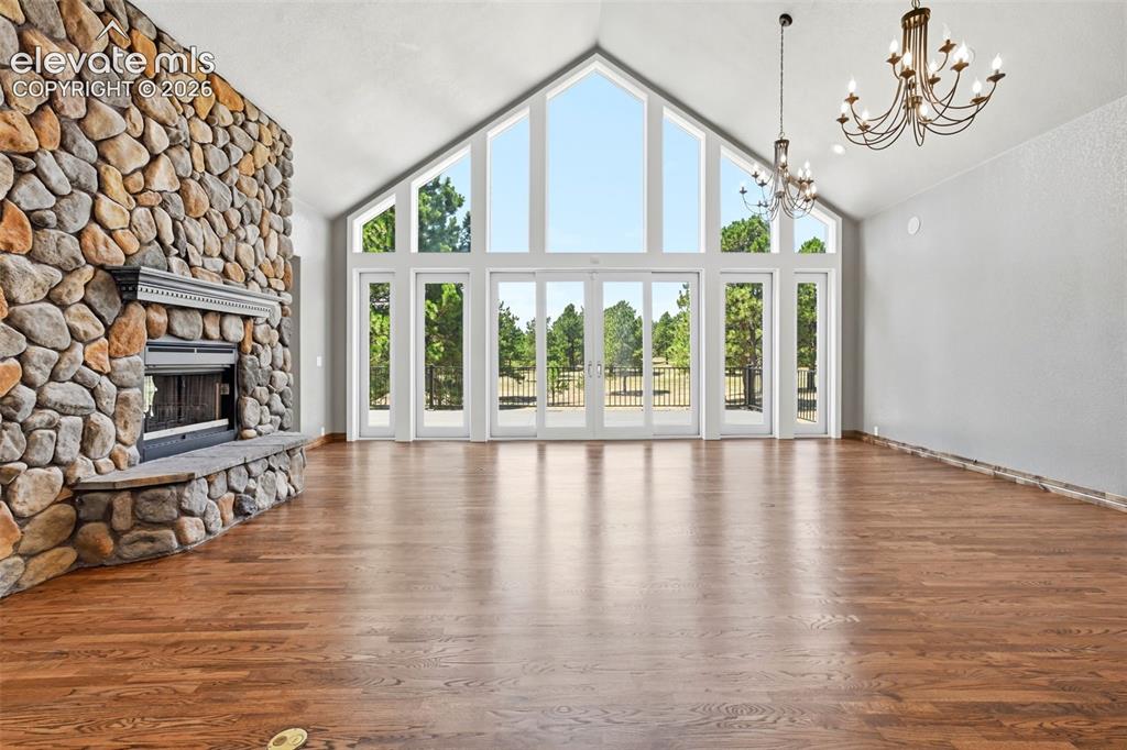 Image 4 of 40: Great room featuring a vaulted ceiling with exposed beams, a floor-to-ceili