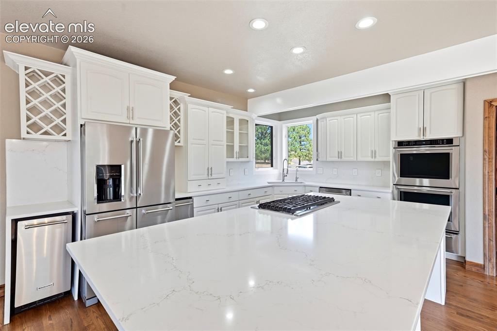 Image 7 of 40: Contemporary kitchen featuring a large central island, stainless steel appl