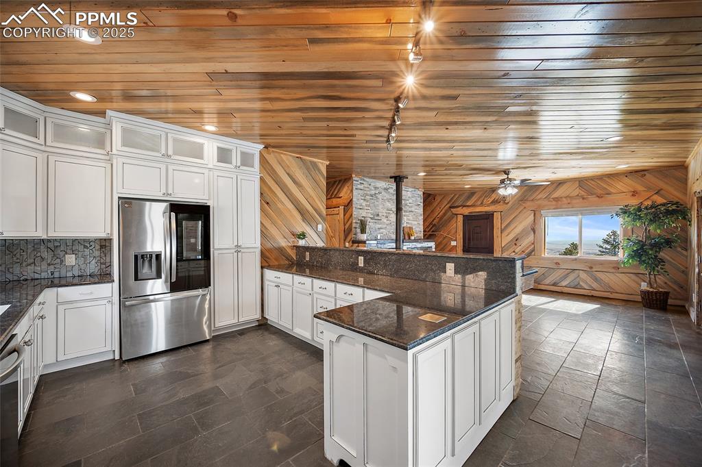 Image 11 of 50: View of open floor plan designer kitchen leading into the open living room 