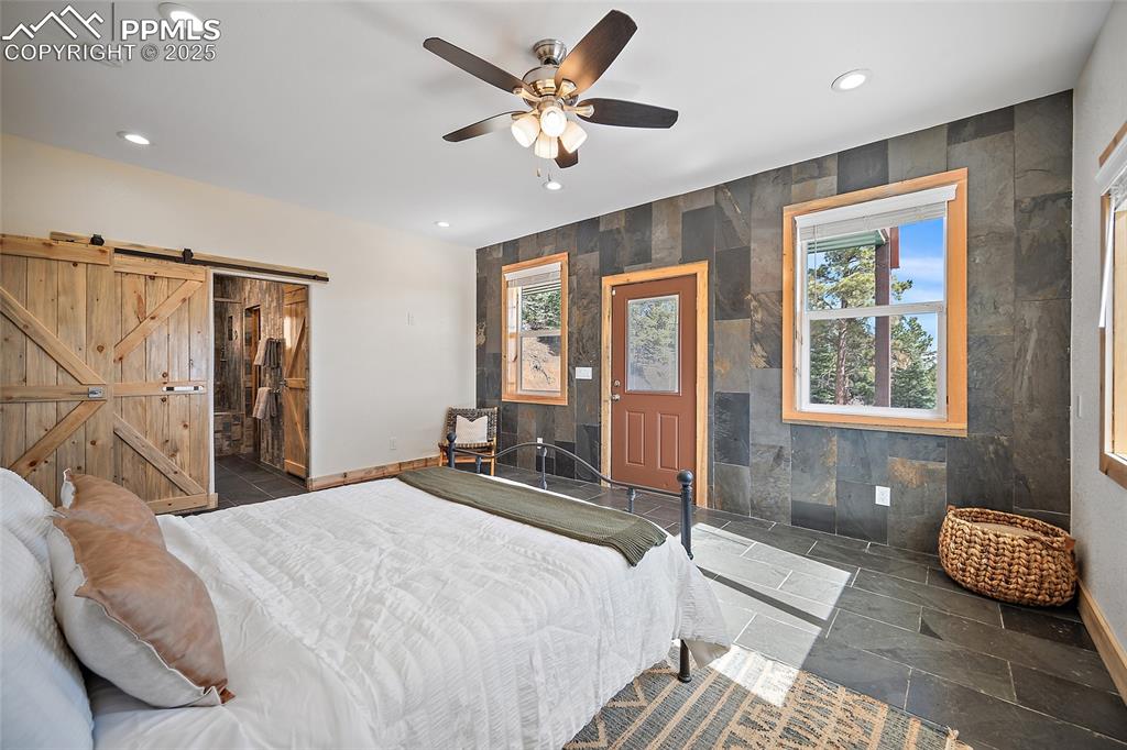 Image 13 of 50: Primary suite featuring entry to a covered patio with stunning views of the