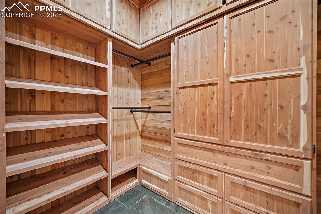 Image 16 of 50: Luxurious walk-in floor to ceiling cedar closet