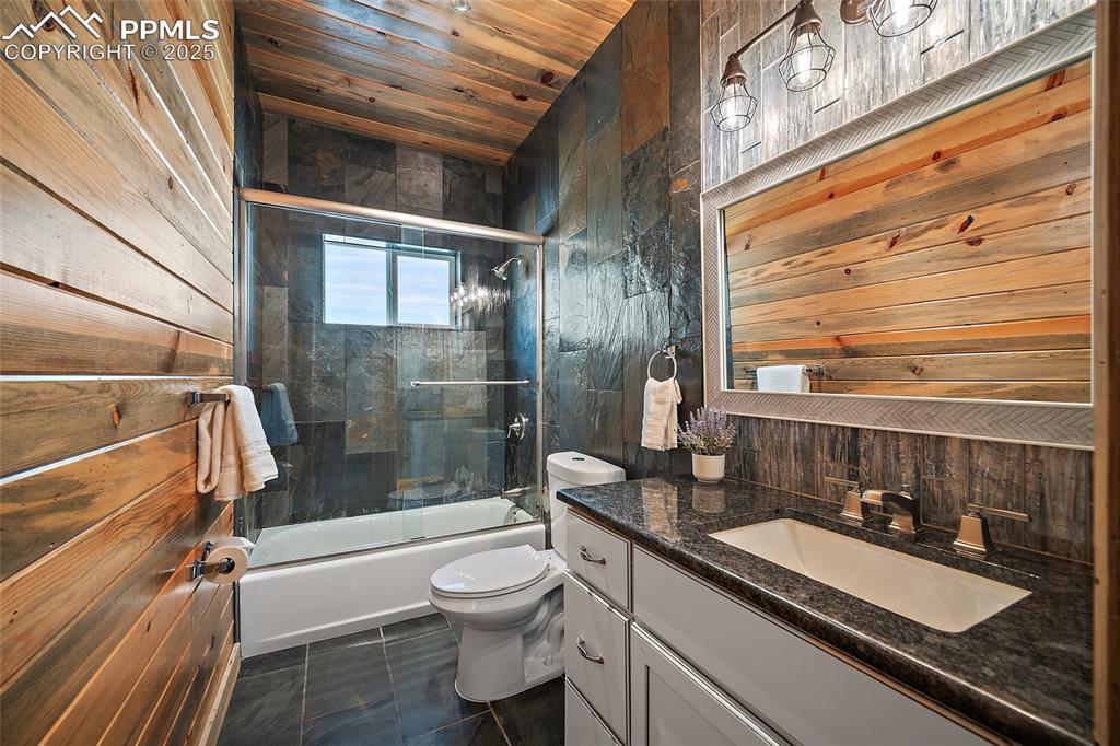 Image 23 of 50: Secondary bathroom on main floor featuring natural stone slate flooring and