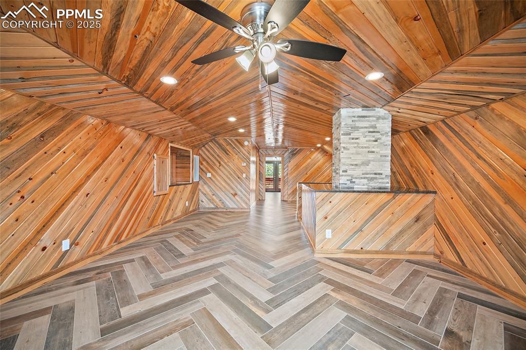 Image 25 of 50: Beautiful custom woodwork in upstairs family room with elegant stone counte