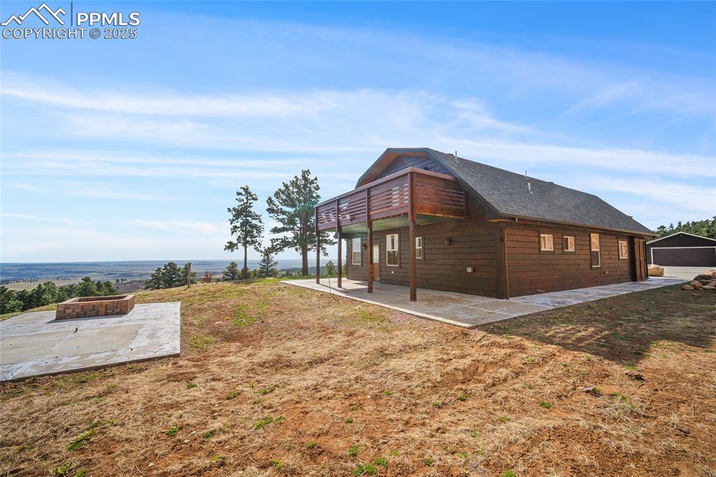 Image 3 of 50: Back exterior view with fire pit area