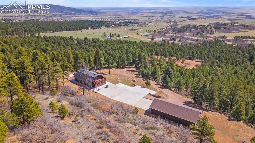Image 4 of 50: Aerial side view of property with beautiful view