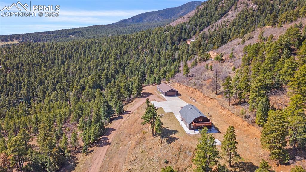 Image 47 of 50: Aerial view featuring the drive and Colorado mountainous feel of this stunn